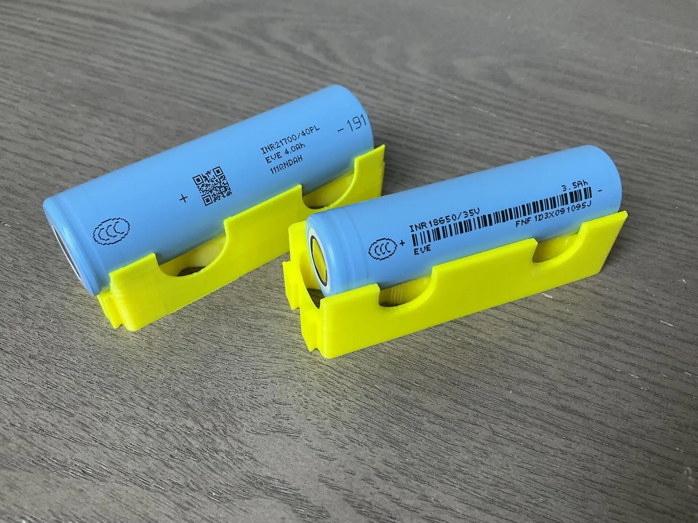 Lithium-ion cells in 18650 and 21700 formats on a surface