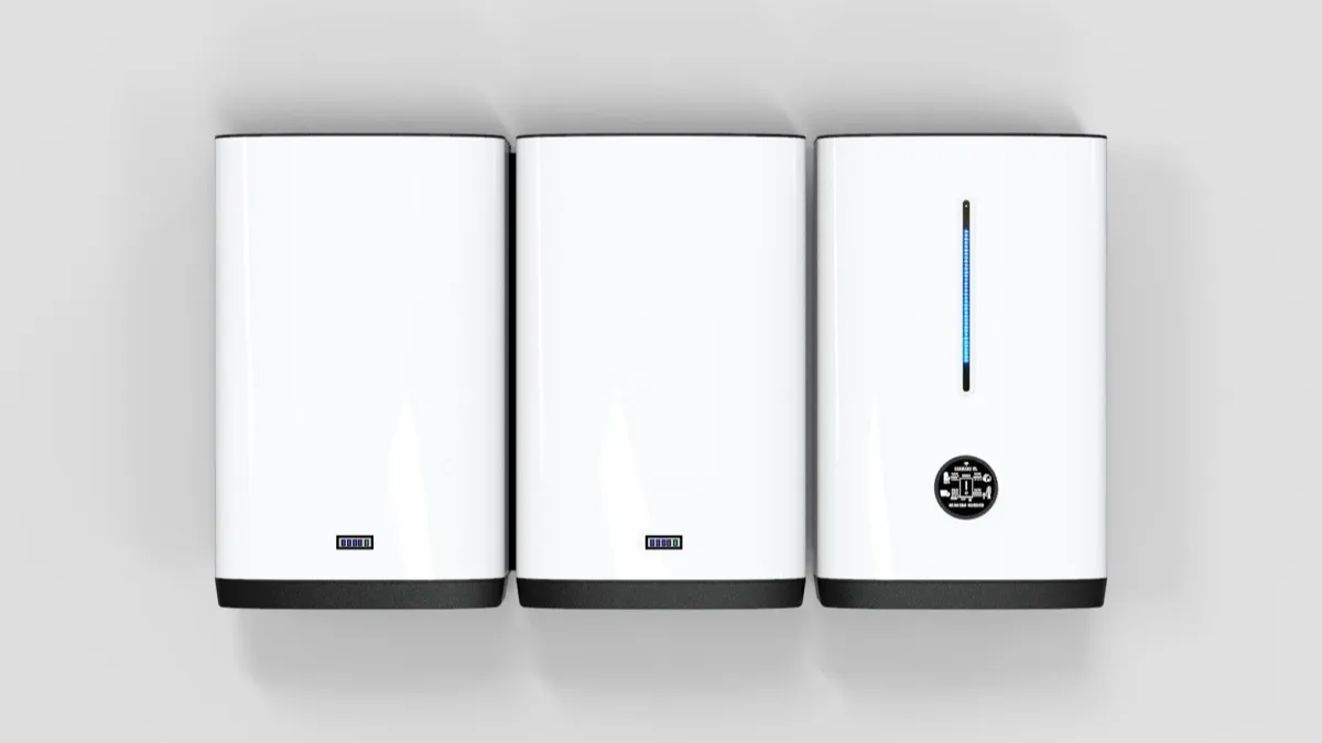 Tres módulos blancos de un sistema doméstico de almacenamiento de energía en una pared